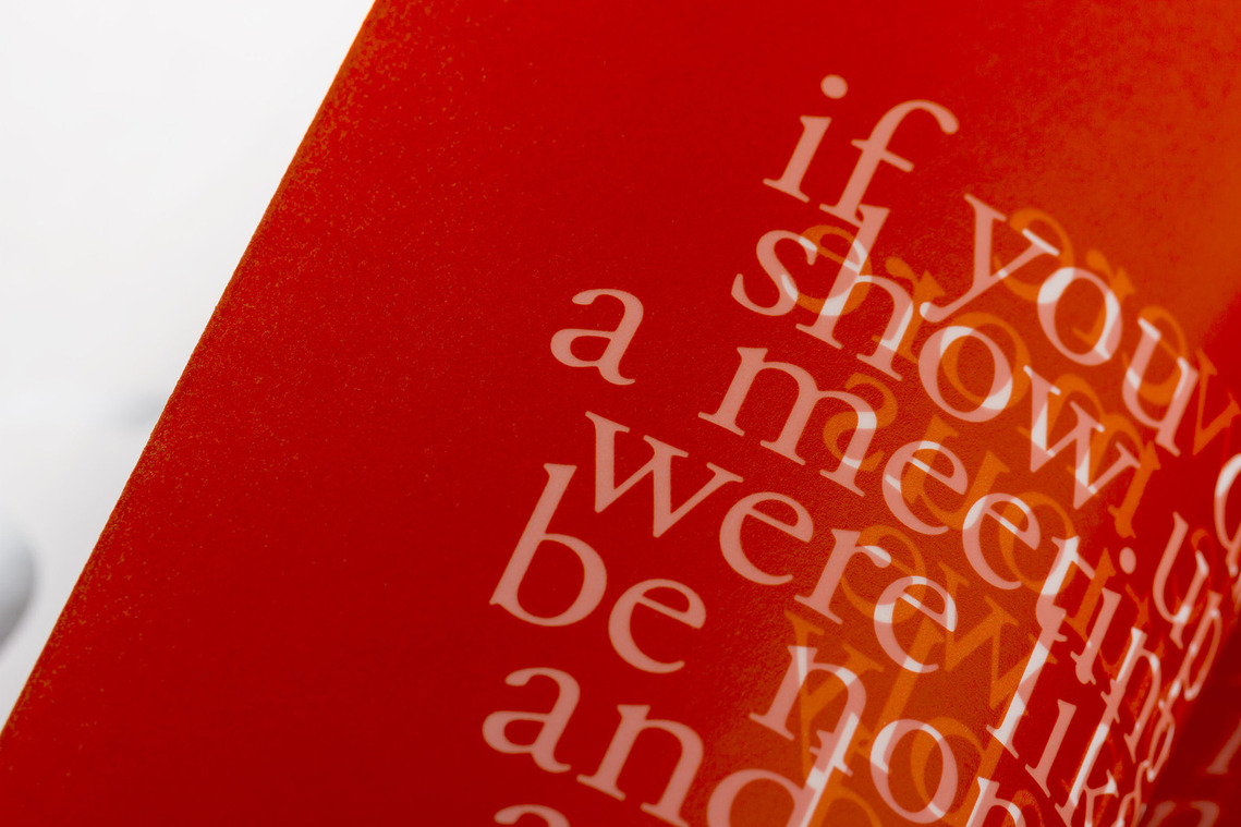 Zoomed in detail of one of the translucent text pages of the AIGA SF 25th Anniversary book. This shows white text knocked out of a red page.