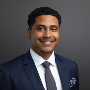 Formal portrait of a Wealth Manager from First Republic Bank against a gray background. The photographic lighting on the face is considered 