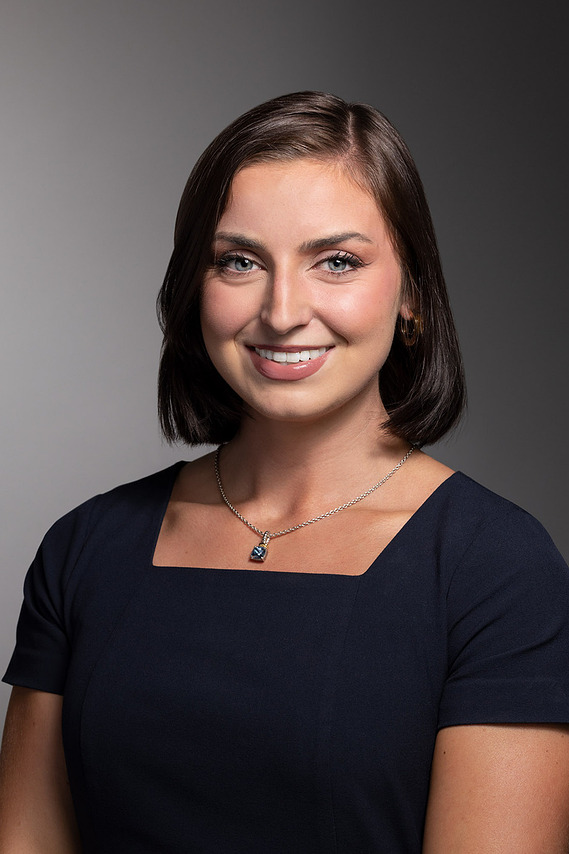 Portrait of an employee of Lexicon Branding in Sausalito, CA. The background is a seamless backdrop that gradates from light- to dark-gray, and the lighting style on the subject can be described as 