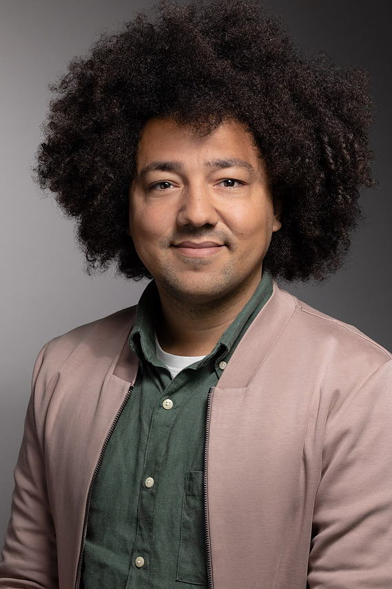 Portrait of an employee of Lexicon Branding in Sausalito, CA. The background is a seamless backdrop that gradates from light- to dark-gray, and the lighting style on the subject can be described as 