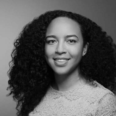 Black and white portrait of an employee of Lexicon Branding in Sausalito, CA. The background is a seamless backdrop that gradates from light- to dark-gray, and the lighting style on the subject can be described as 