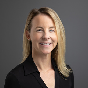 Formal portrait of a Wealth Manager from First Republic Bank against a gray background. The photographic lighting on the face is considered 