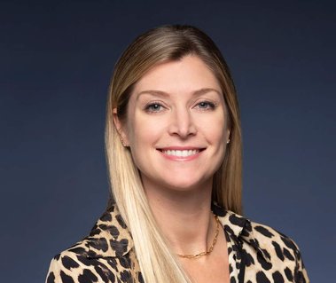 Color portrait of an investment banker against a blue, seamless background