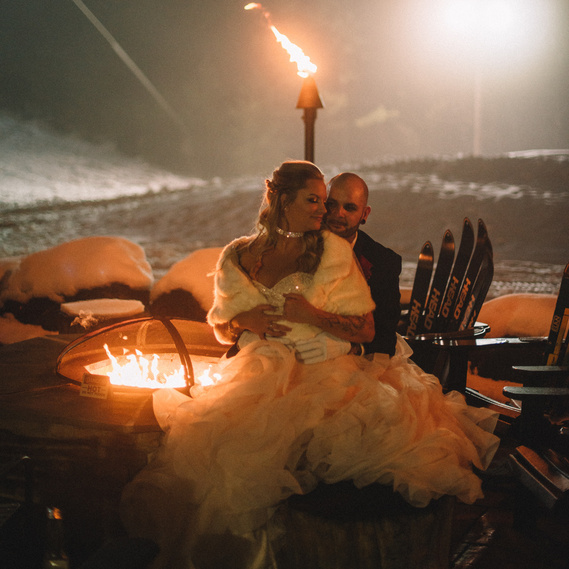 bride and groom by fire pit at Camelback resort