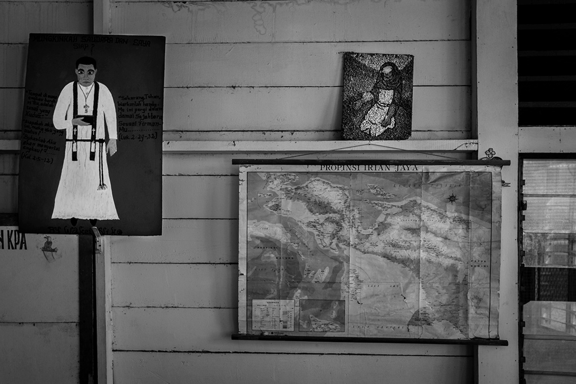 Image of priest figure and Irian Jaya map. In the past Papua was called Irian Jaya. President Abdurrahman Wahid (Gus Dur), changed the name of Papua in 2000.