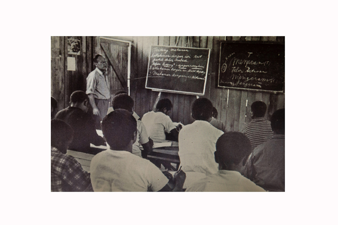 A Dutch priest taught Papuan children in Akimuga, Papua in the 1950s. (Repro photograph form OFM archive).