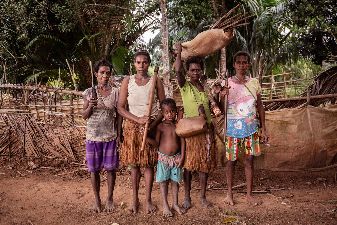 Boven Digul, Papua, Indonesia, 2019. A number of women and children showed preparations to go to the forest. They brought axes, fishing rods, cutlery and wood with coals of fire. The forest is a kitchen for indigenous communities.