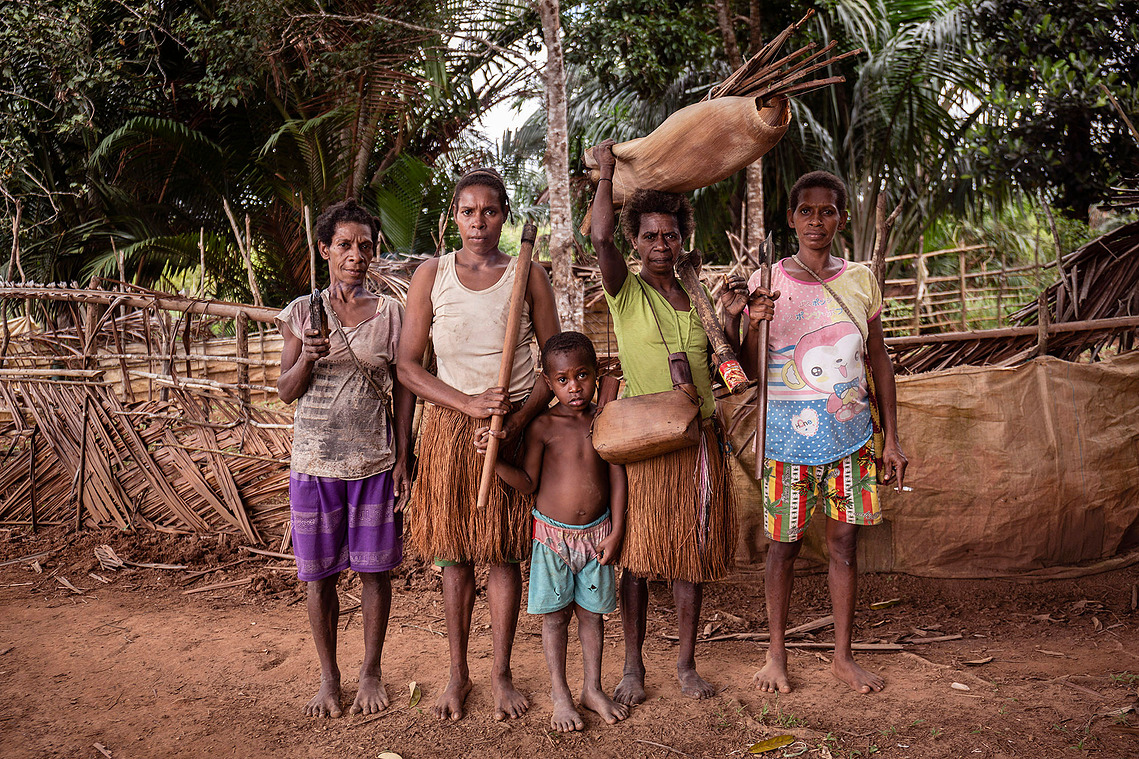 Boven Digul, Papua, Indonesia, 2019. A number of women and children showed preparations to go to the forest. They brought axes, fishing rods, cutlery and wood with coals of fire. The forest is a kitchen for indigenous communities.