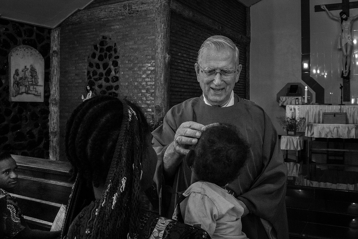 Baptism for the young. Father Lieshout once headed the Teachers Training School (SPG) in Jayapura. Entering retirement in 2007, he returned to Baliem Valley. While executing his pastoral duties, he wrote books.