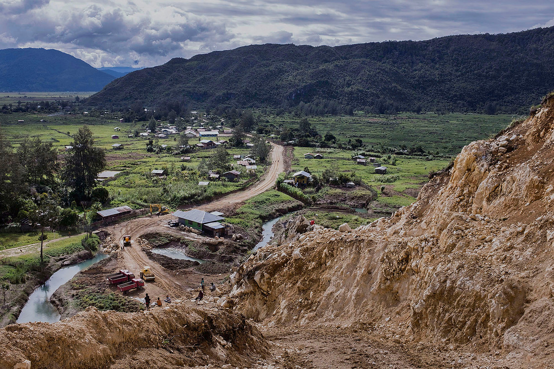 Paniai, Papua, Indonesia, 2015. Trans Papua access road project made by the government to open isolated access. The productive man go to nearby cities although only a few of them go to school and work, mostly unemployed and involved in criminal acts.