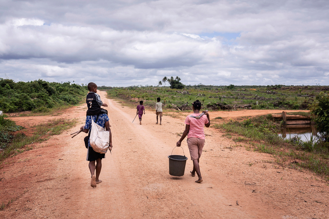 Boven Digul, Papua, Indonesia, 2019. Woman and child looking for foods. Since the forest is being cleared for oil palm plantations, they have to walk farther to get foods.
