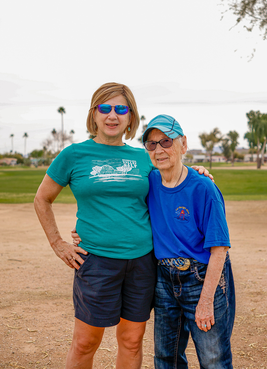 A senior woman and her adult daughter enjoy an active day outdoors, showcasing healthy aging, strong family bonds, and an energetic lifestyle in a candid portrait.