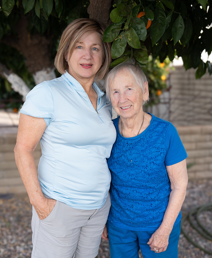 An outdoor mother-daughter portrait featuring a 90-year-old woman and her adult daughter, celebrating family, heritage, and natural moments together.