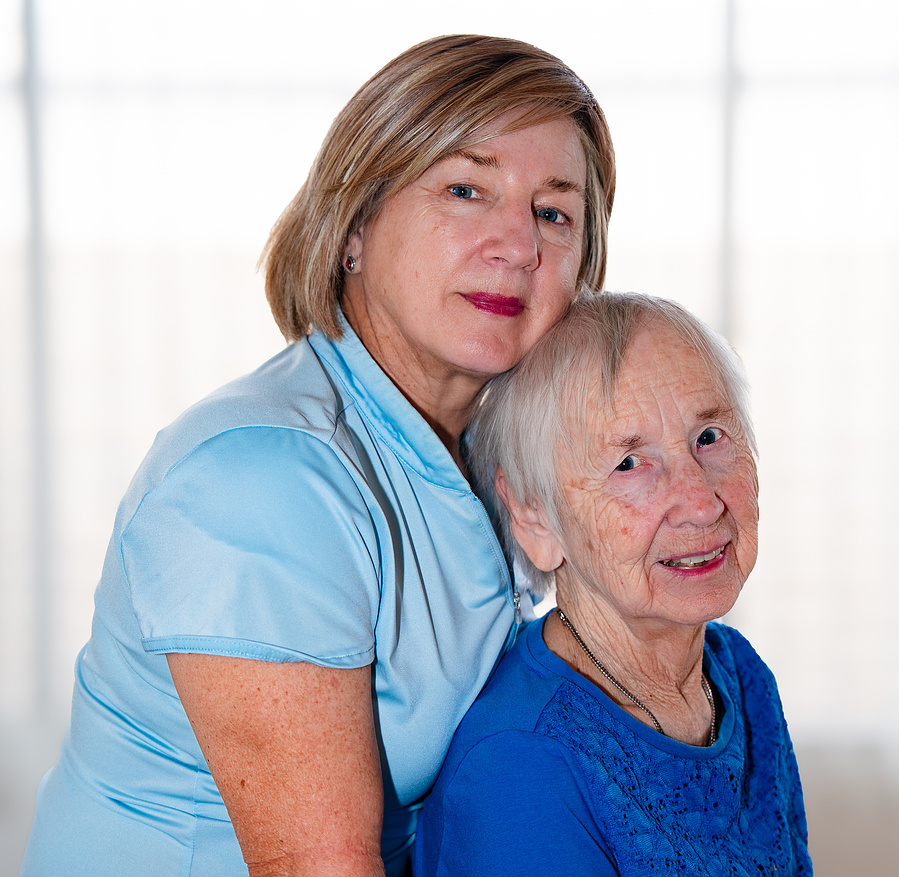 This comforting embrace between a 90-year-old woman and her adult daughter beautifully illustrates love, support, and aging with grace.