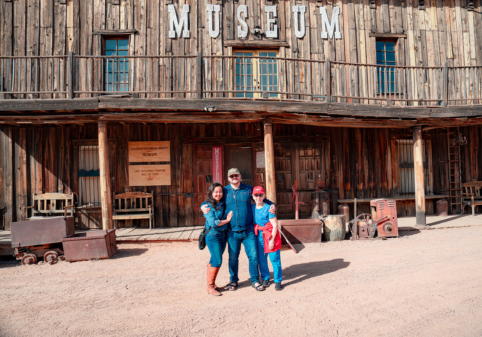 Casual portrait moment in front of the Goldfield Ghost Town museum with rustic Western details.