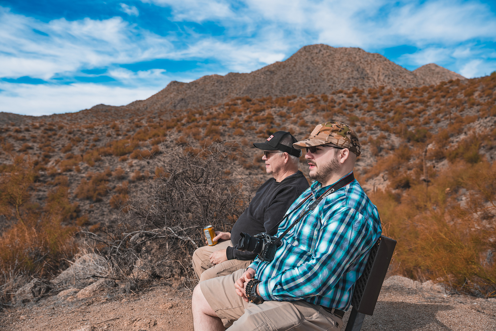 Father and Son enjoying desert views while seated on a rock outcrop at Saguaro Lake.