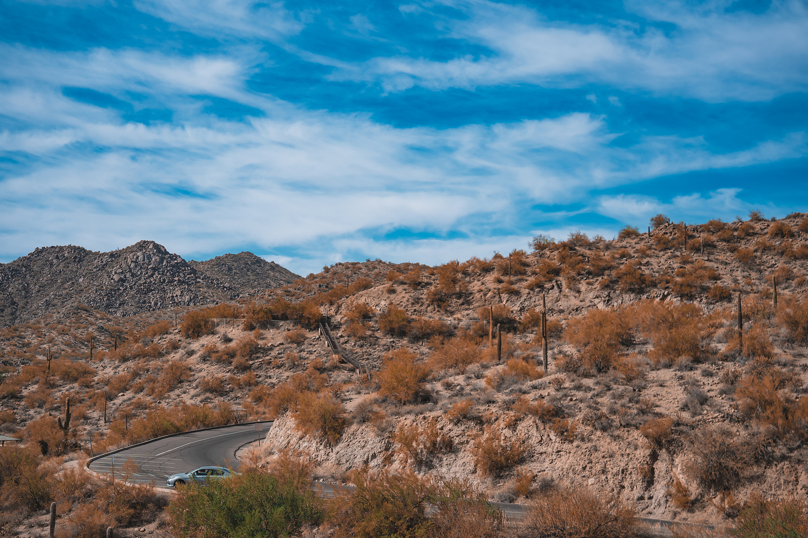 Scenic Sonoran Desert terrain with dry brush, boulders, and open skies near Saguaro Lake.