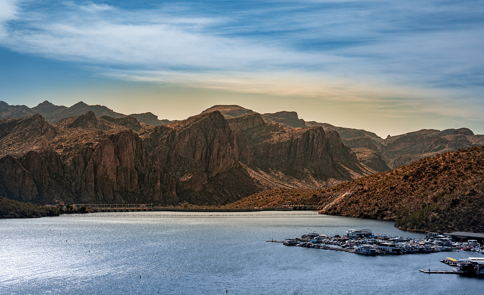 Arizona mountain silhouettes at sunset, reflected on the still waters of Saguaro Lake.