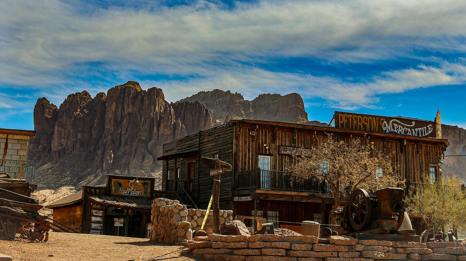 Old mining shack with a stunning backdrop of the Superstition Mountains at Goldfield Ghost Town, Arizona.