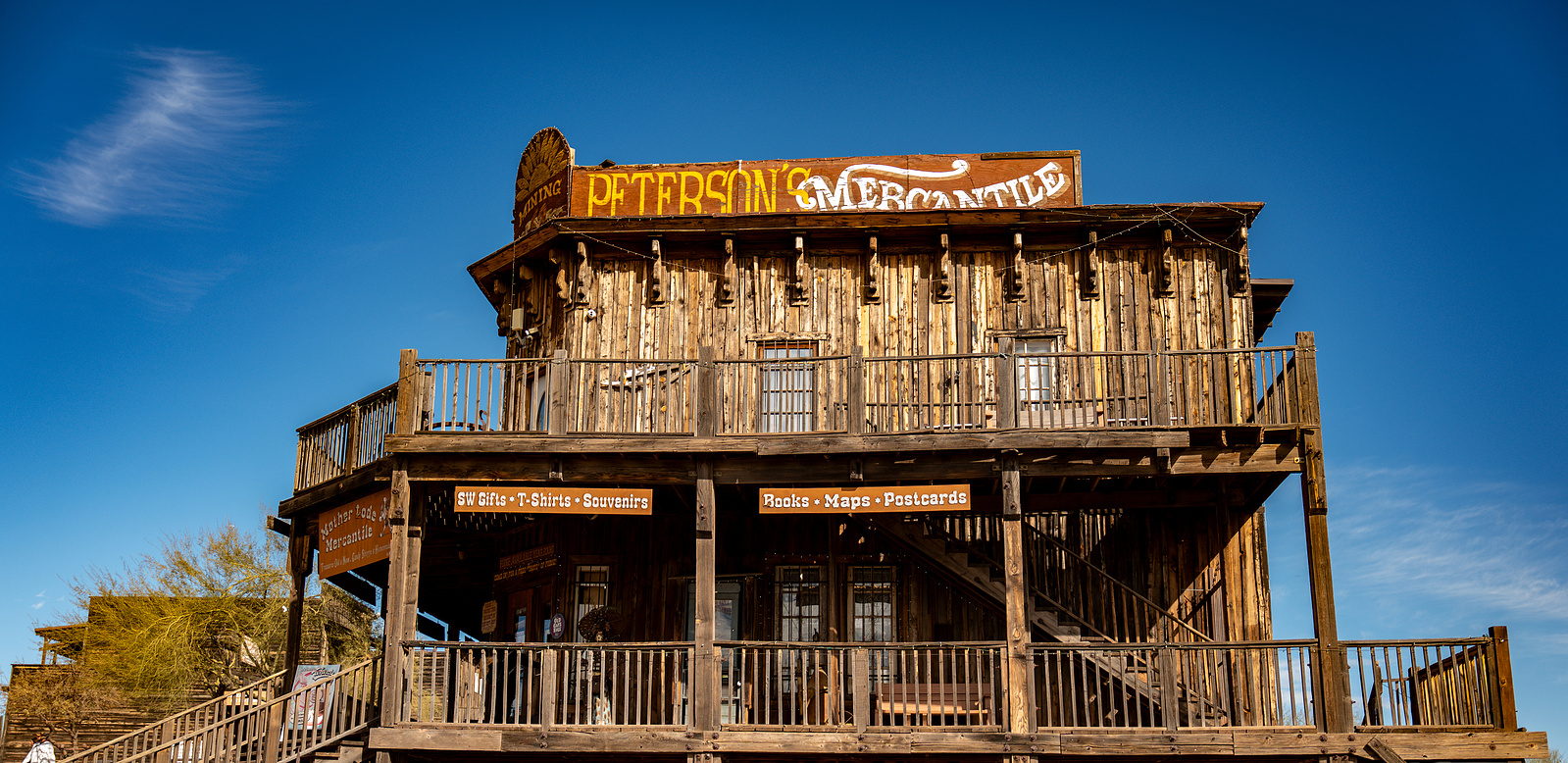 Historic saloon building at Goldfield Ghost Town in Arizona under bright blue skies, perfect for Western-themed photography.