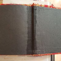 Inside back cover of the book, showing middle of the black end paper saturated with glue.