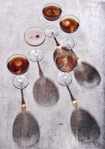 smokey manhattan cocktails standing on rustic background