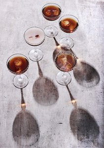 smokey manhattan cocktails standing on rustic background