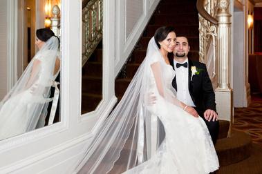 Bride on Groom's lap with reflection in mirror. 