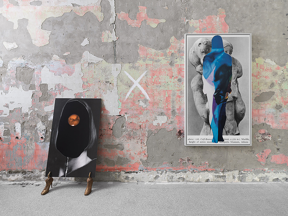 2 pictures, one hanging and the other propped up by shoes, leaning against the wall