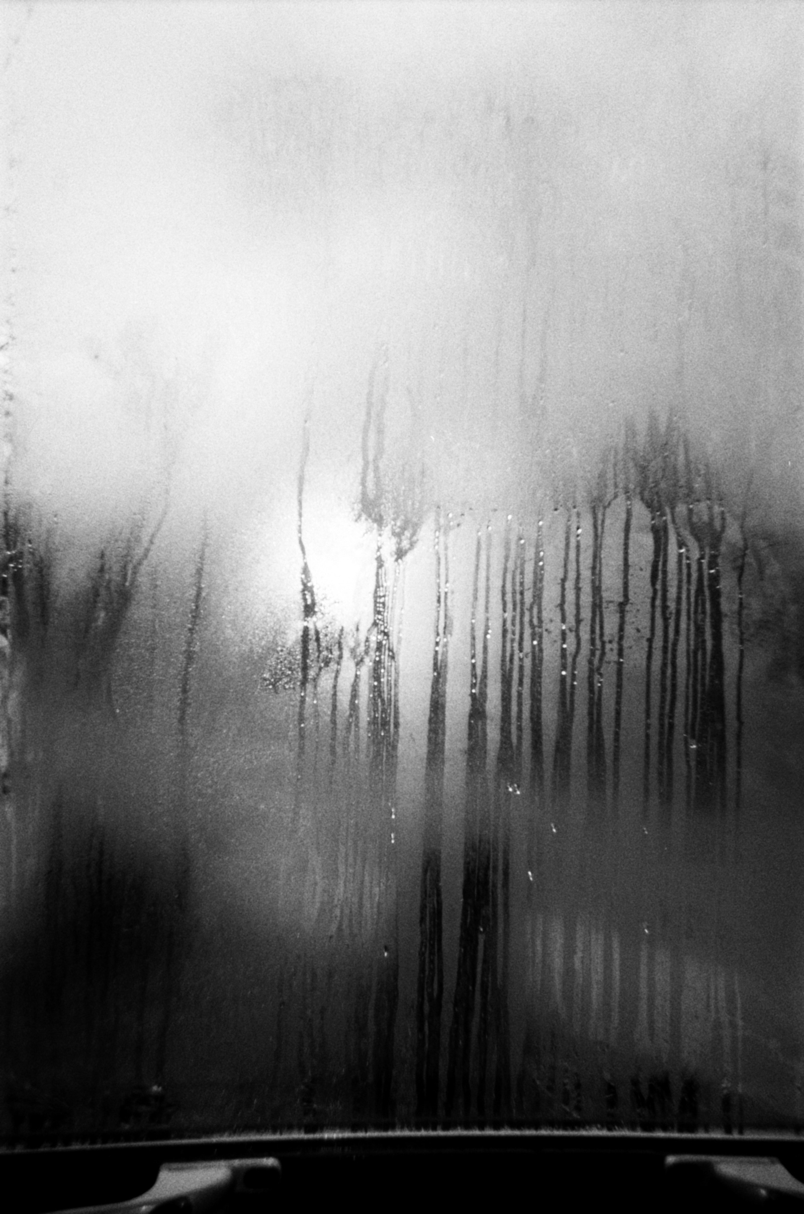 Condensation on a window with drips of water running down