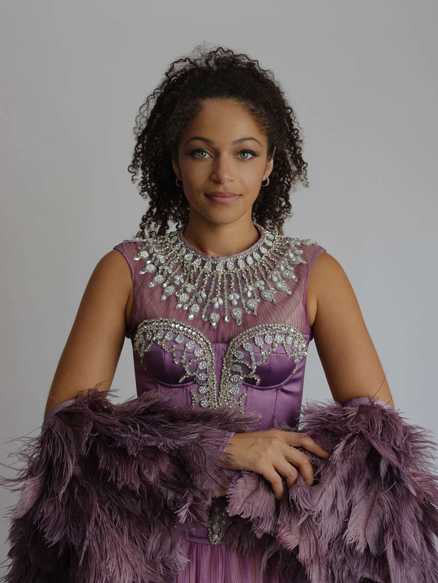purple ostrich feather off the shoulder cape worn with sparking rhinestone dress