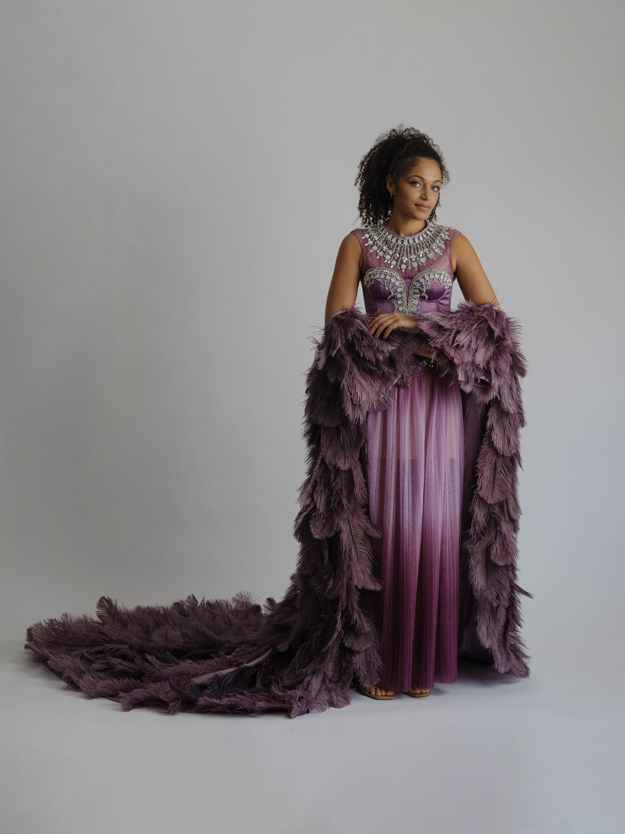 purple ostrich feather off the shoulder cape worn with sparking rhinestone dress