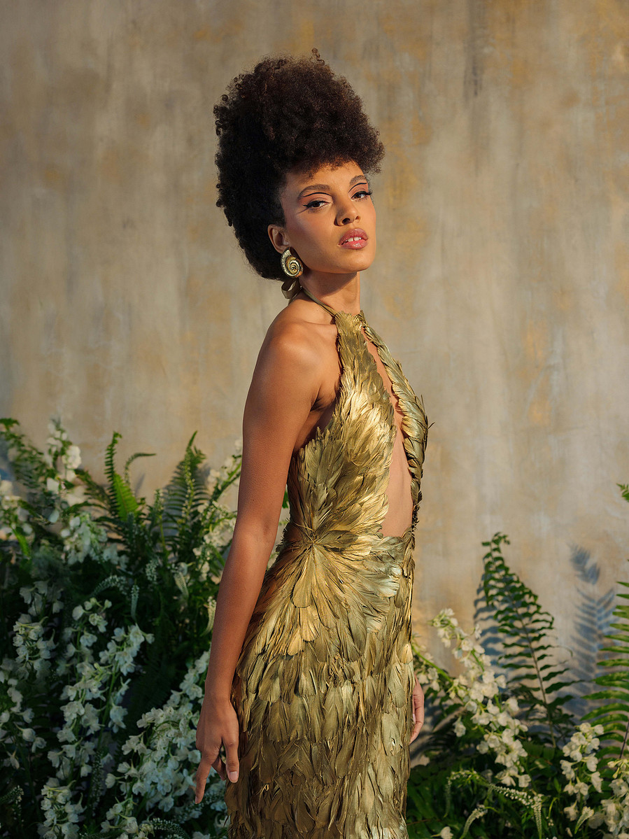 high fashion couture gold feather dress with wing top and mermaid skirt
