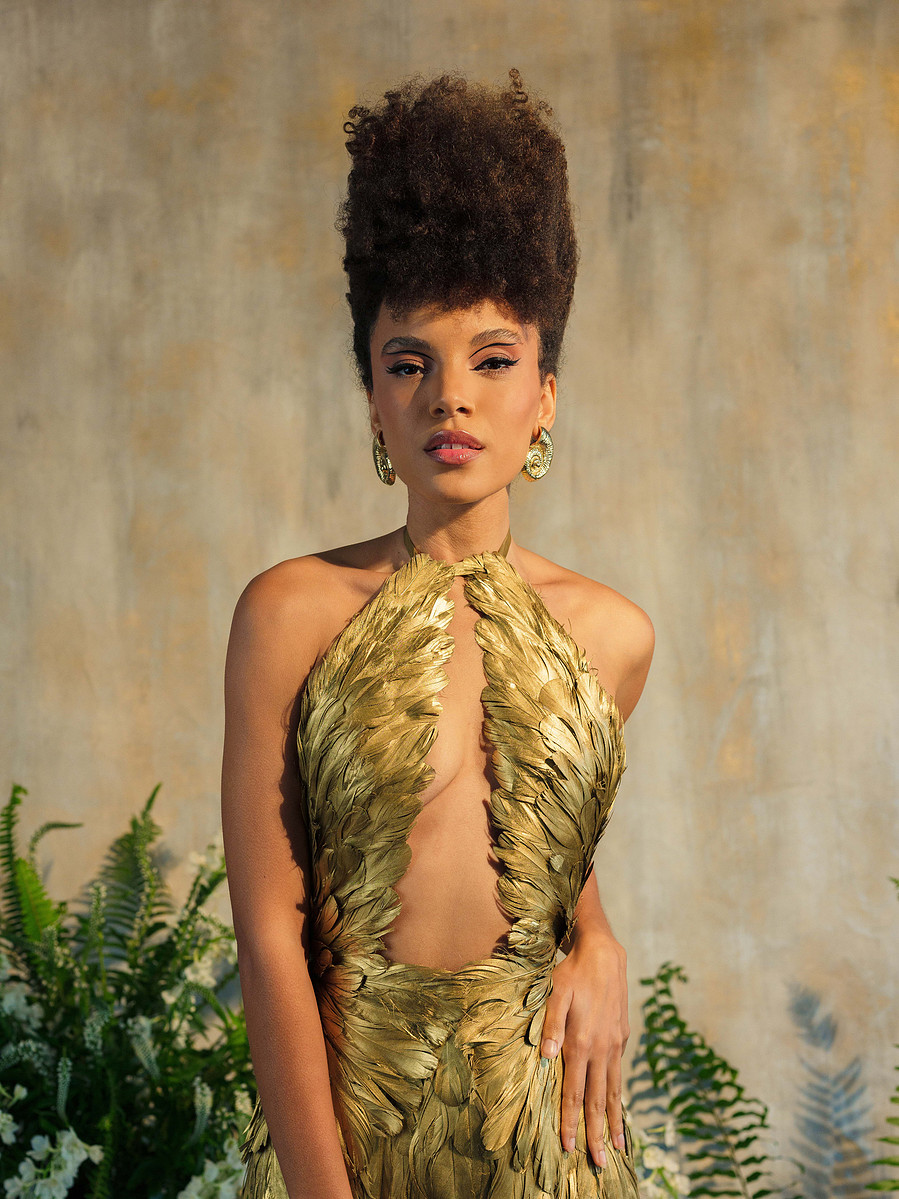 high fashion couture gold feather dress with wing top and mermaid skirt