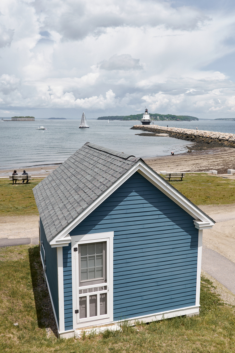 View of Spring Point Ledge Lighthouse with Fort Gorges off the coast of Portland, Maine.