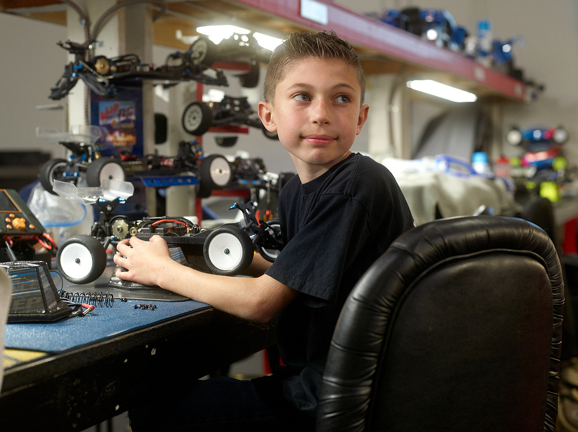 A young driver poses with his RC car inside Whip It RC Raceway & Hobbies in Reno, NV.