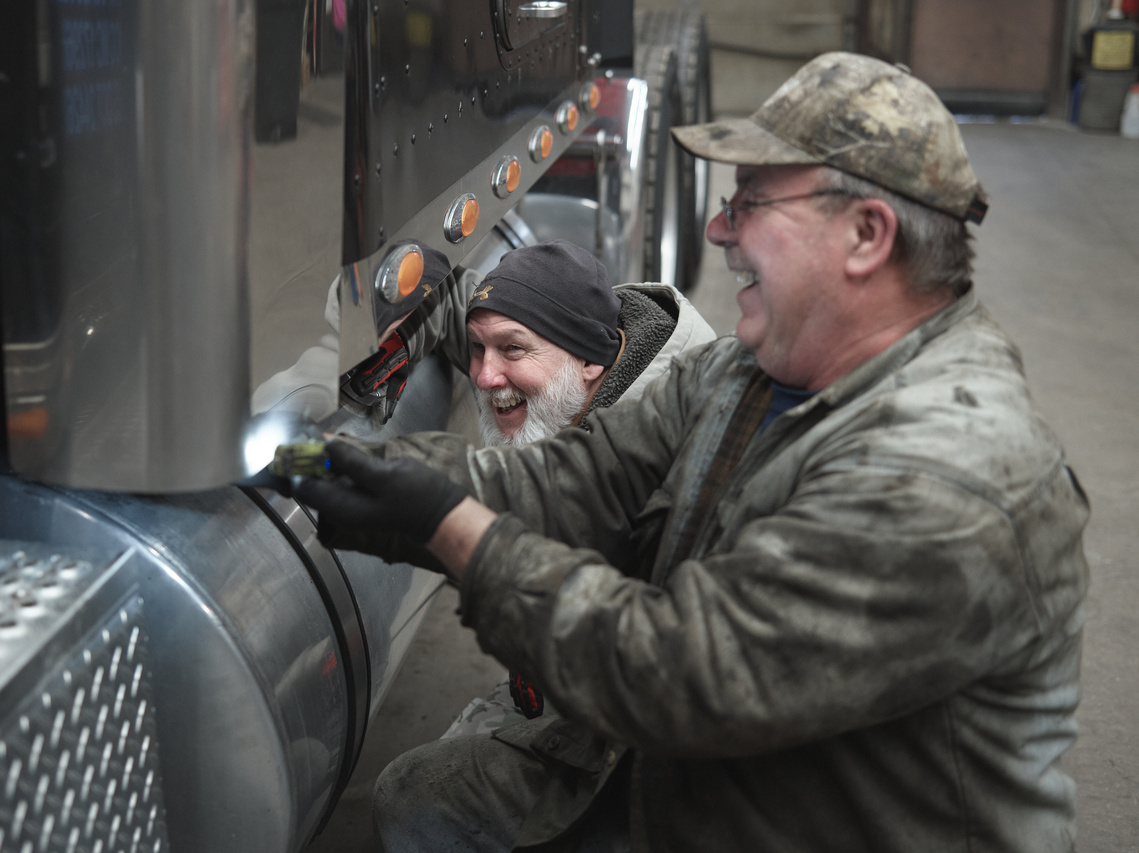 Men working on a semi-truck.