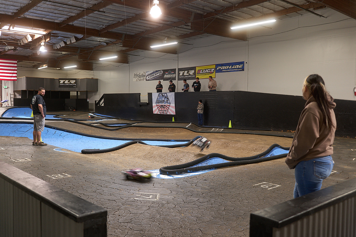 RC cars race around the dirt racetrack inside Whip It RC Raceway & Hobbies in Reno, NV