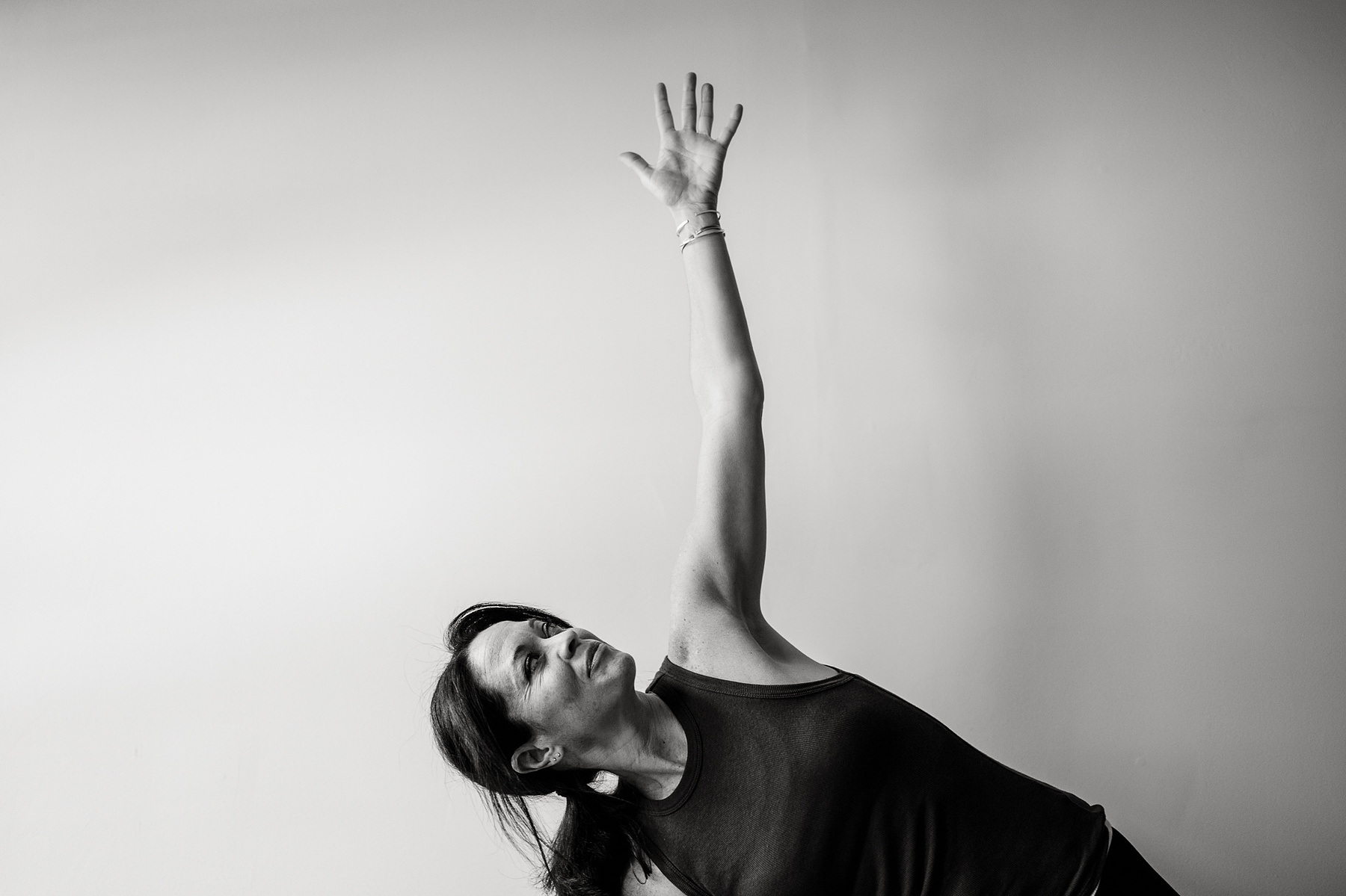 Yoga teacher Jill Barry in triangle pose in the Norwood photography studio of Boston yoga photographer Korri Leigh Photography