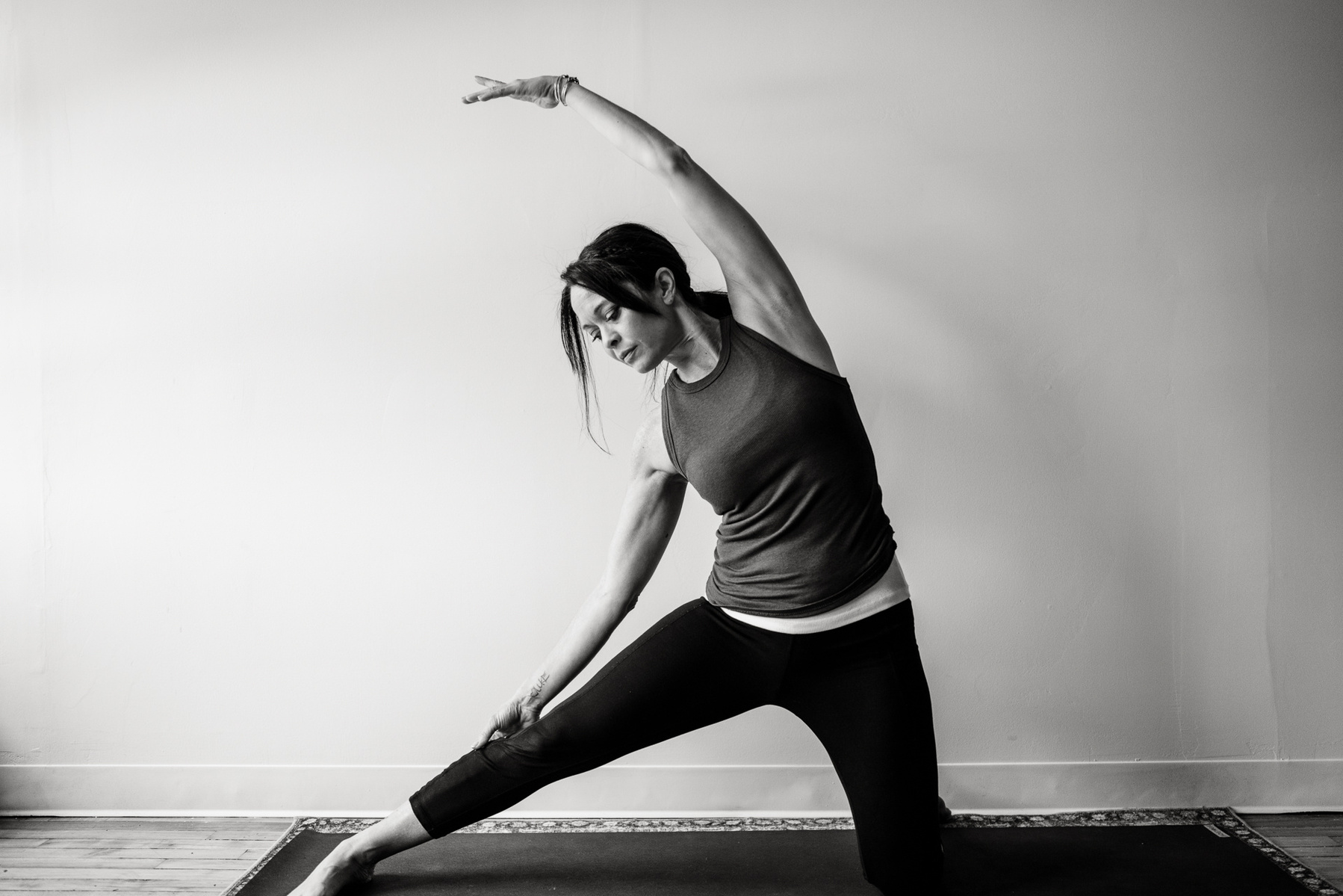 Yoga teacher Jill Barry in gate pose in the Norwood photography studio of Boston yoga photographer Korri Leigh Photography
