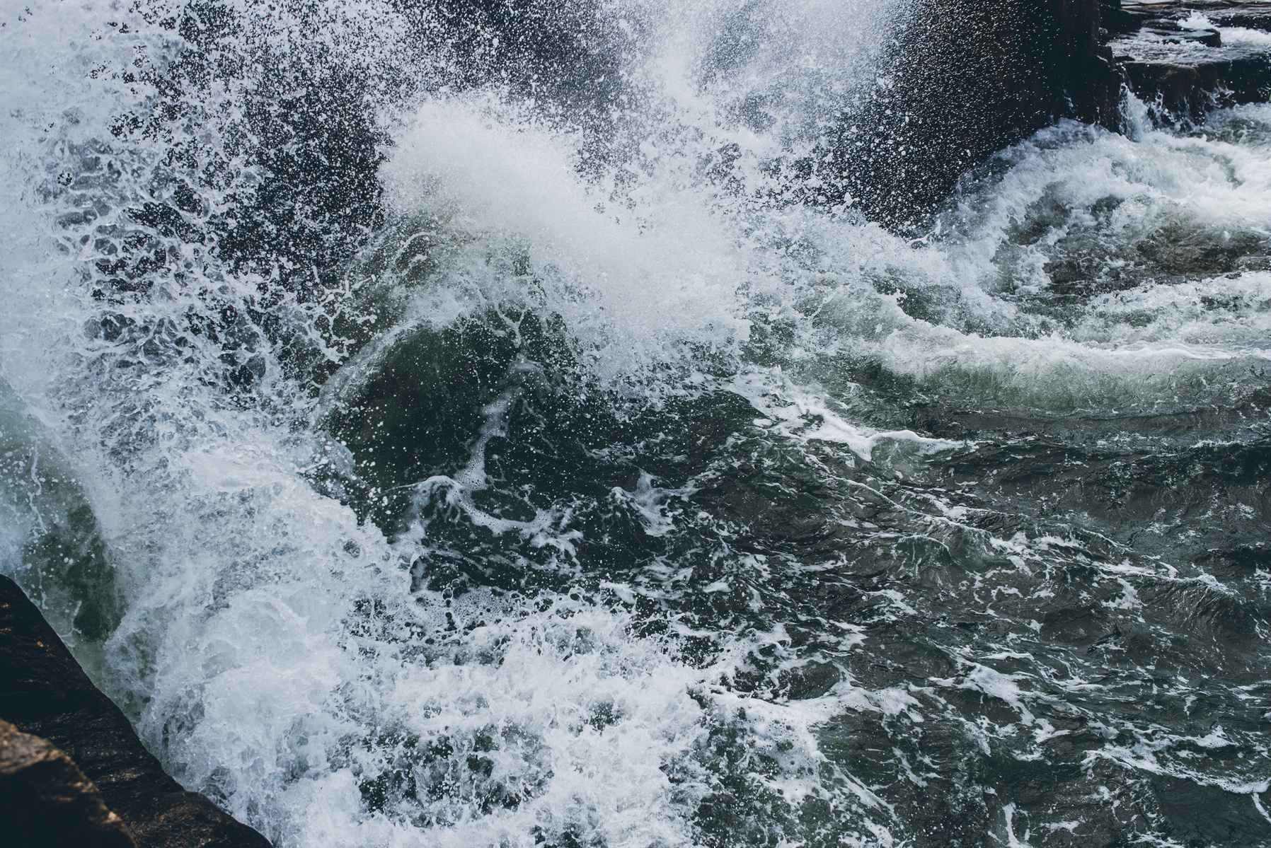 A crashing wave in Thunder Hole in Acadia National Park taken by Boston landscape photographer Korri Leigh Crowley