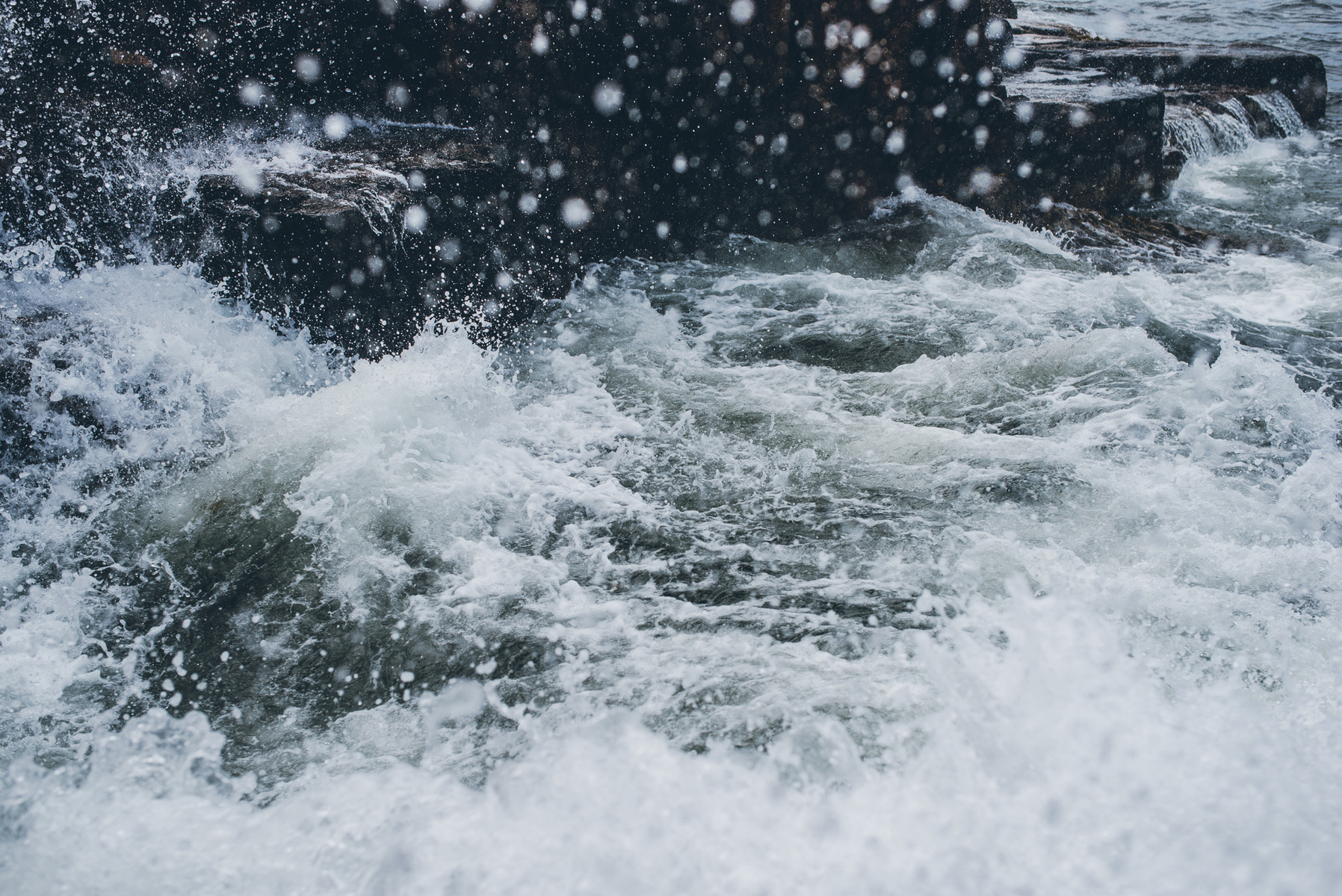 A crashing wave in Thunder Hole in Acadia National Park taken by Boston landscape photographer Korri Leigh Crowley