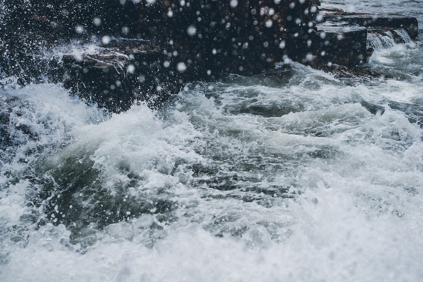 A crashing wave in Thunder Hole in Acadia National Park taken by Boston landscape photographer Korri Leigh Crowley