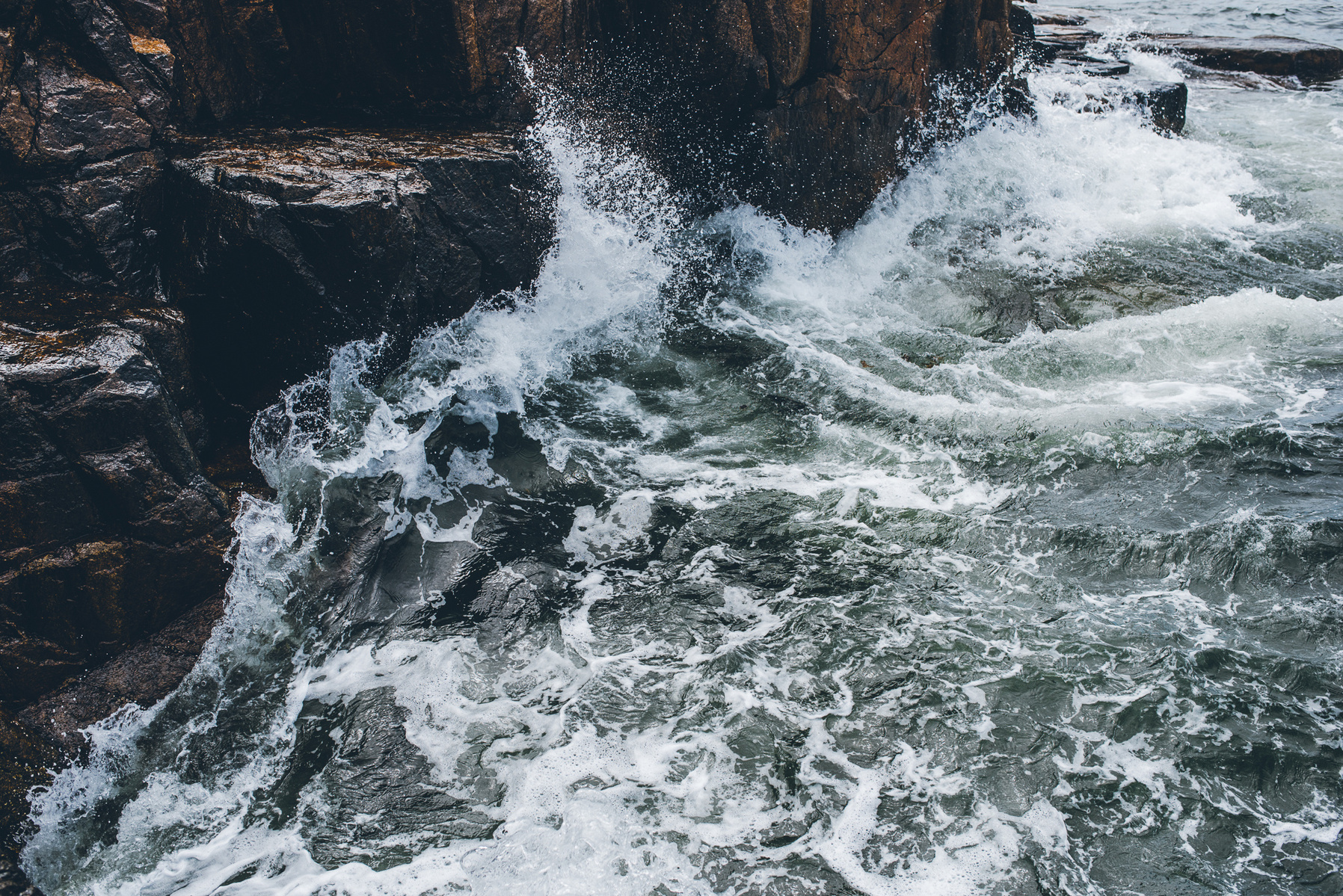 A crashing wave in Thunder Hole in Acadia National Park taken by Boston landscape photographer Korri Leigh Crowley