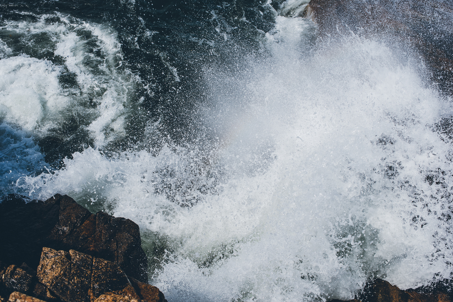 A crashing wave in Thunder Hole in Acadia National Park taken by Boston landscape photographer Korri Leigh Crowley