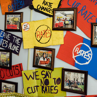 Medicaid service themed art hangs on a wall.