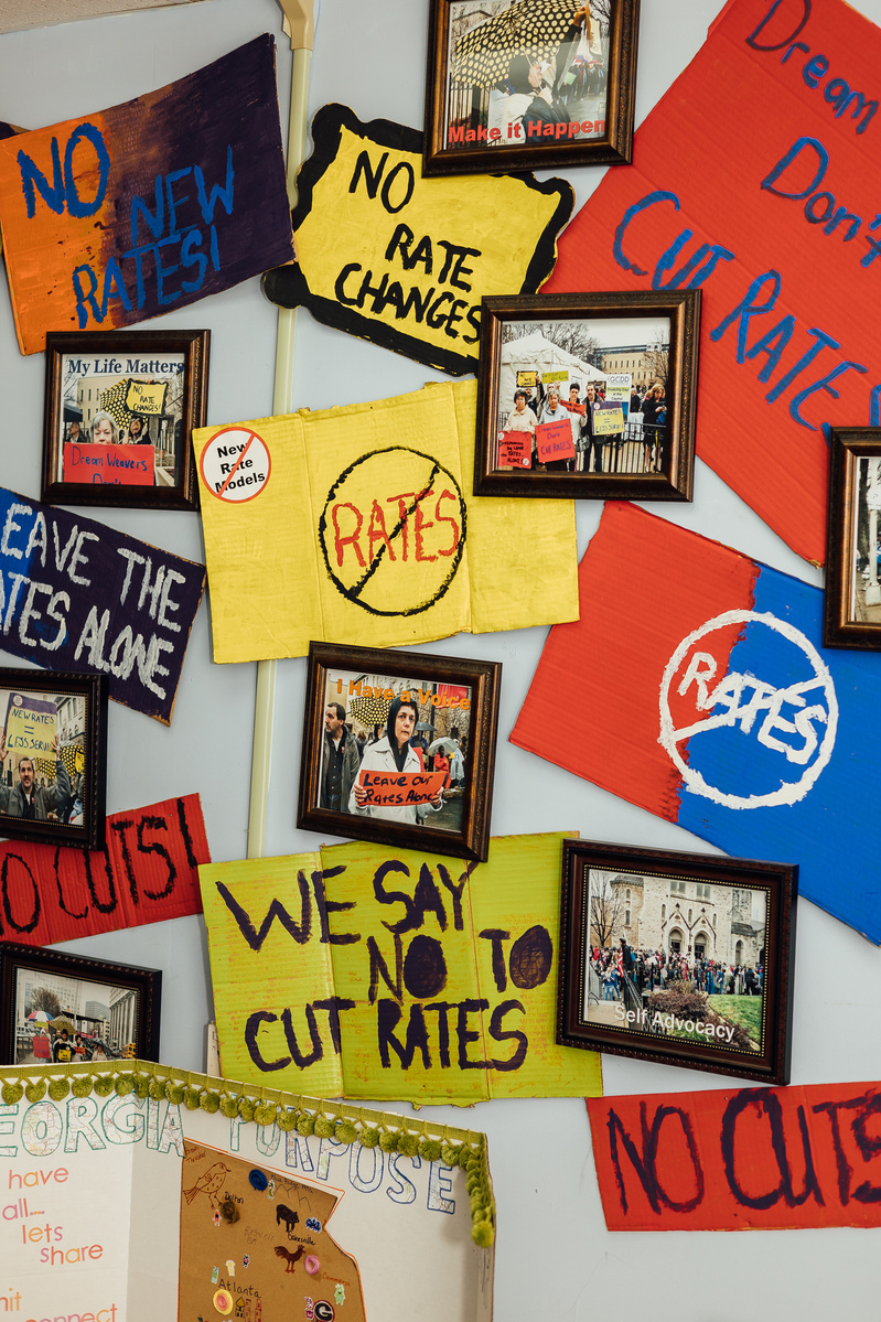 Medicaid service themed art hangs on a wall.