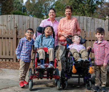 A family poses for a photo with four children.