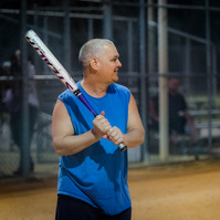 Man swings baseball bat.