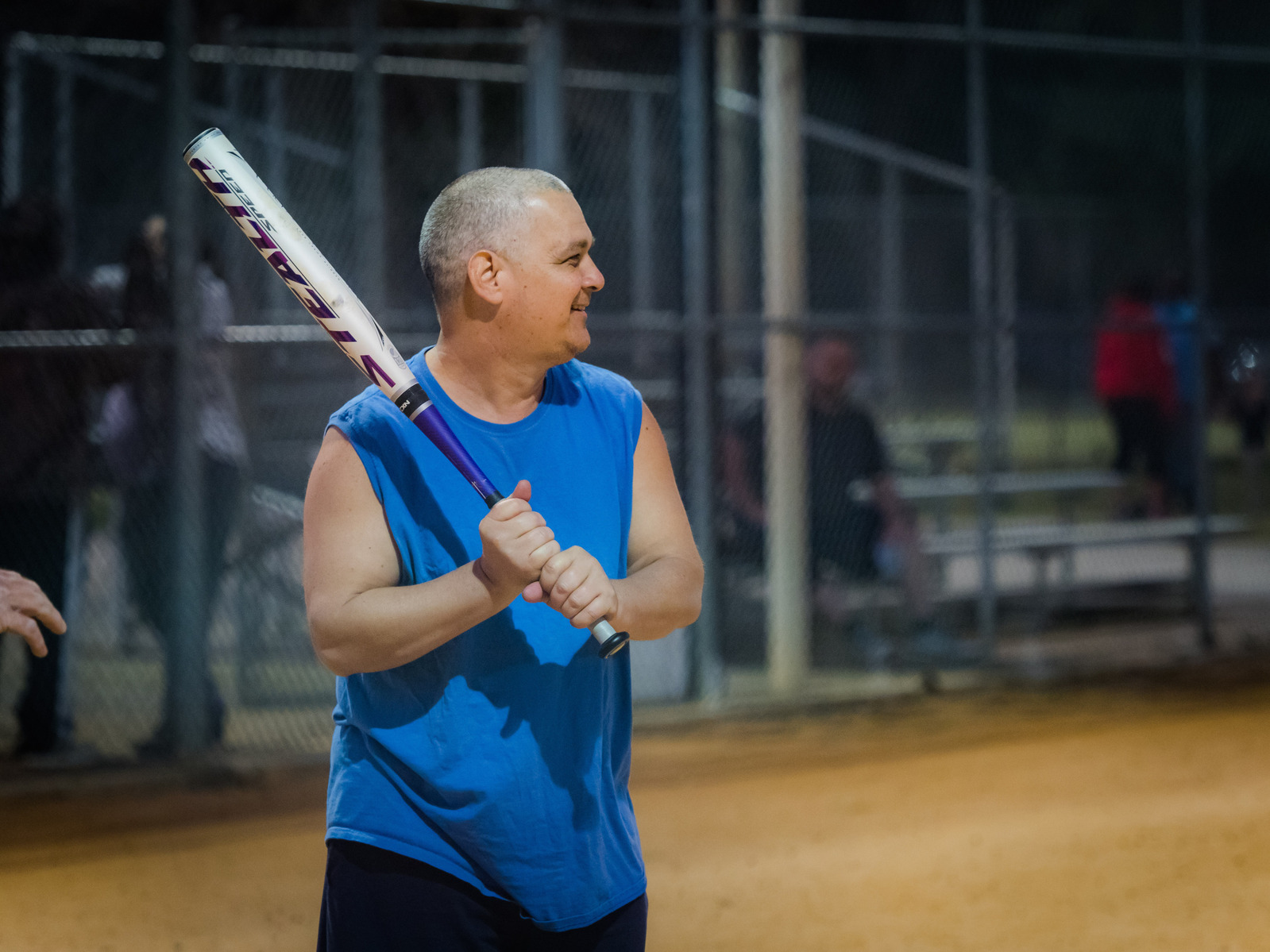 Man swings baseball bat.